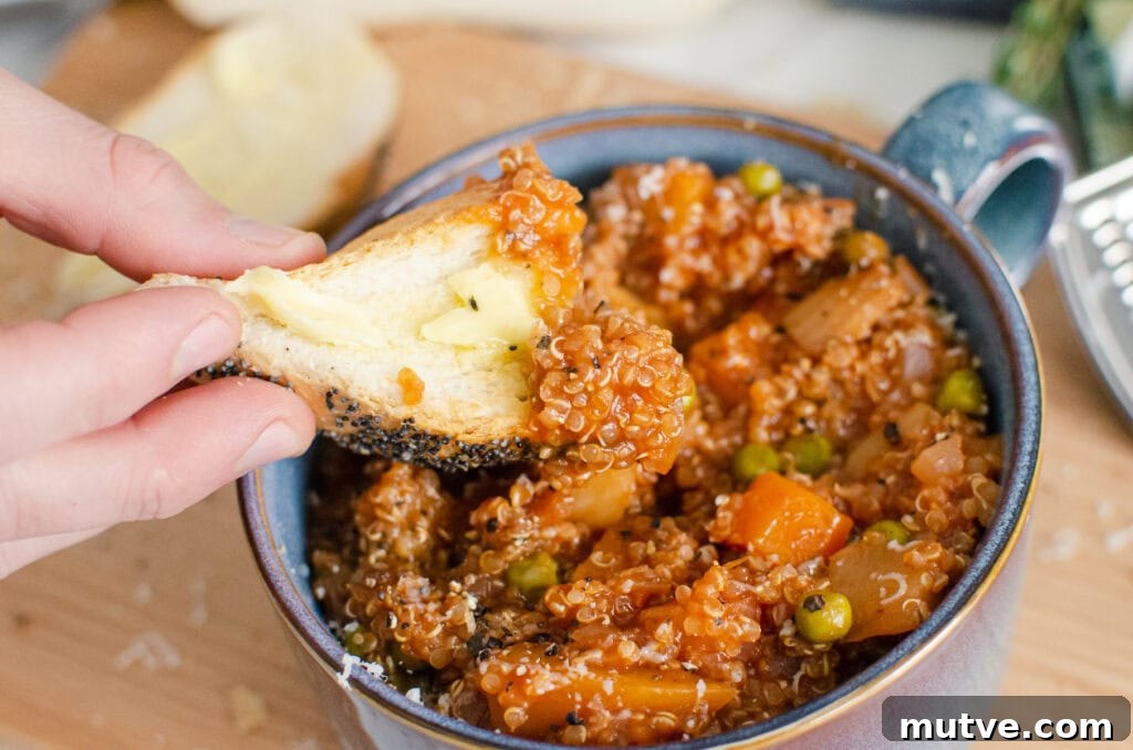 One-Pot Quinoa Vegetable Stew 2 Quinoa Vegetable Stew in a blue bowl with bread getting dipped into the stew