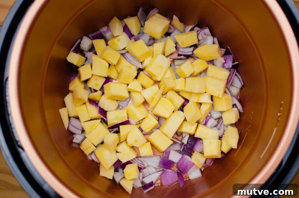One-Pot Quinoa Vegetable Stew 5 Chopped swede and red onion frying in olive oil in a pressure cooker pot