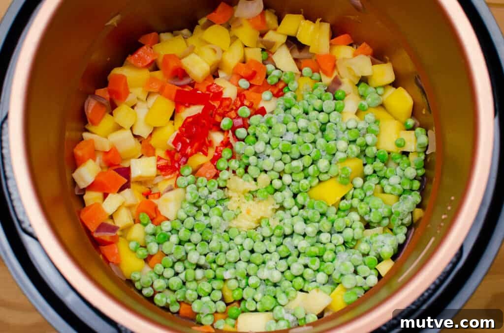 One-Pot Quinoa Vegetable Stew 8 Frozen peas, chopped red chillies and Garlic added to chopped carrots, parsnip, swede and red onion in a pressure cooker pot