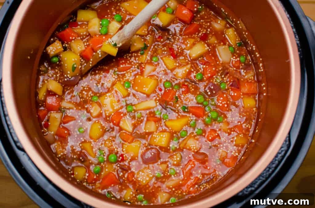 One-Pot Quinoa Vegetable Stew 10 Stirring all the chopped veg together with a wooden spoon