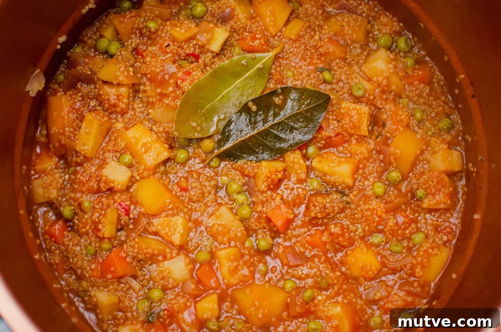 One-Pot Quinoa Vegetable Stew 11 Cooked Quinoa Vegetable stew in a pressure cooker with two bay leafs on top