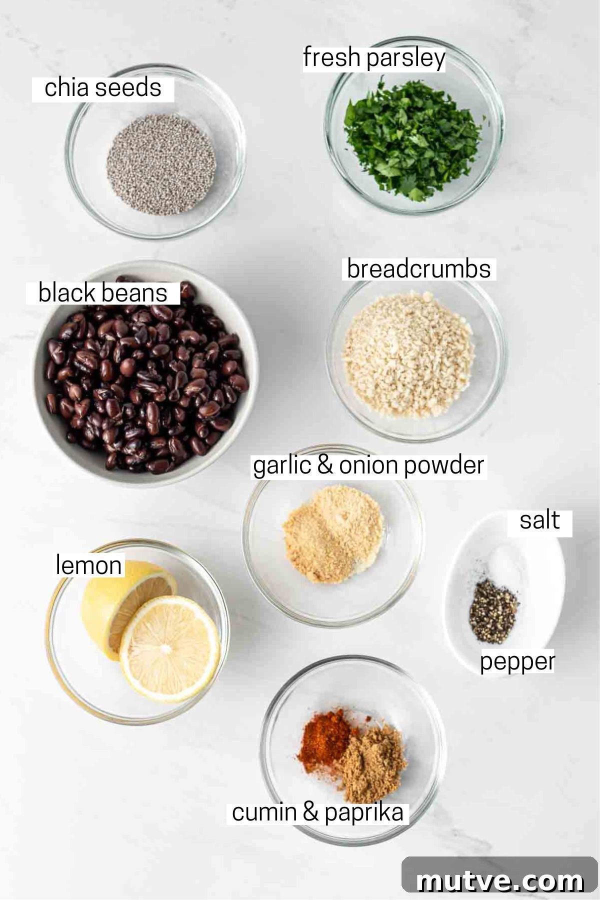 All ingredients needed to make black bean burgers laid out in small bowls.