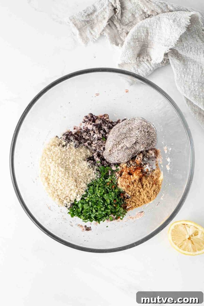 All ingredients for black bean burgers in a glass mixing bowl.