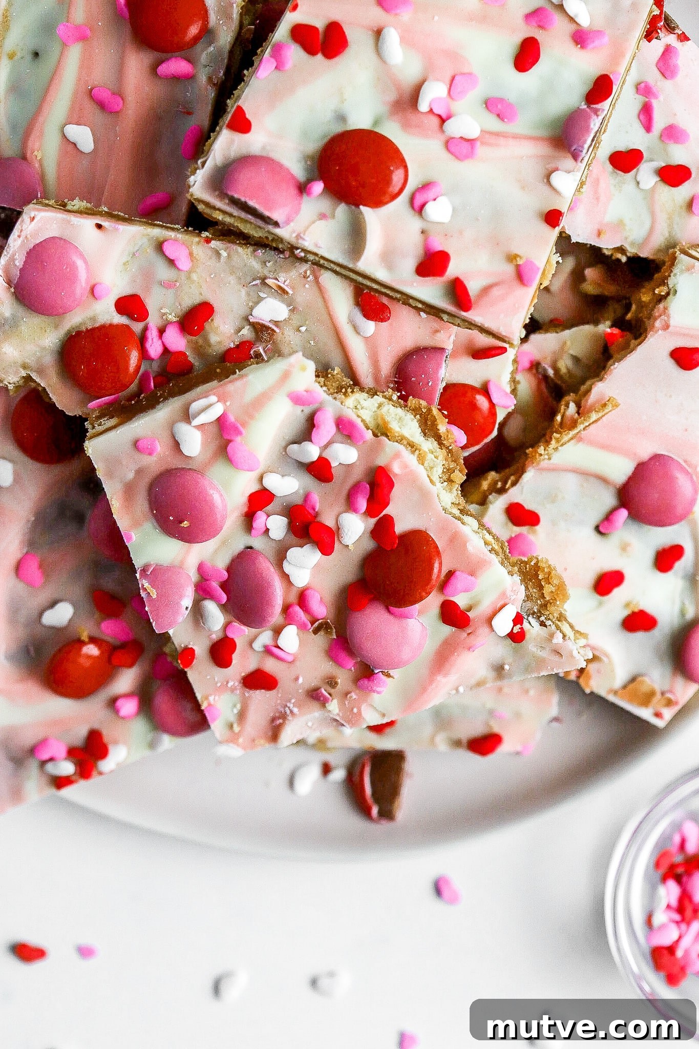 Valentine's Saltine Cracker Toffee Recipe 3 top down view of valentines day crack with heart sprinkles