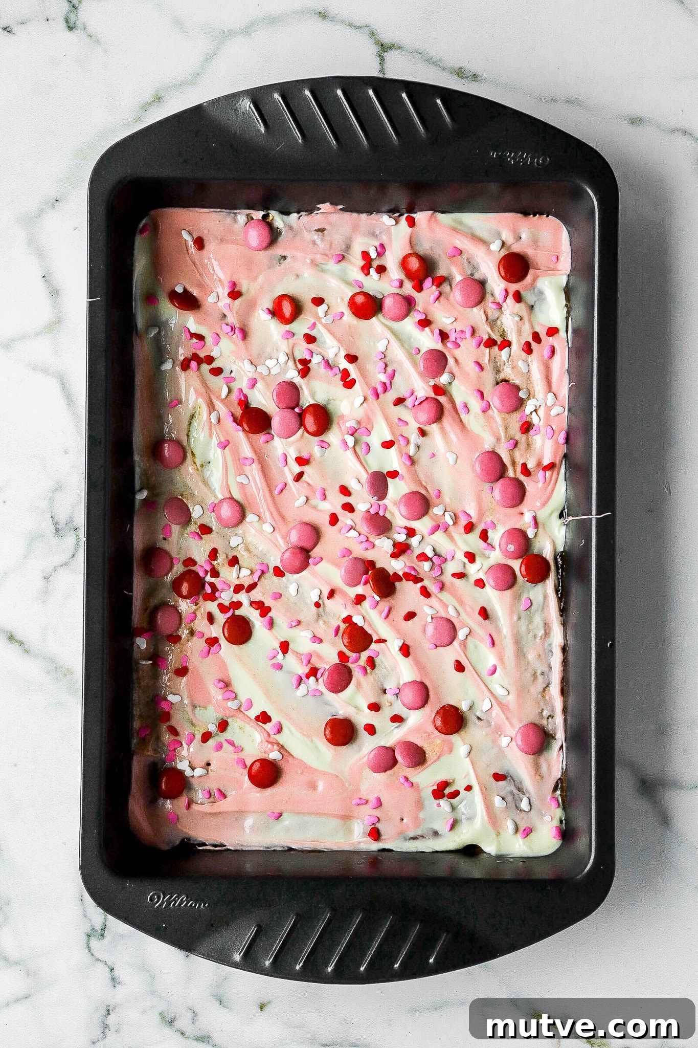 Valentine's Saltine Cracker Toffee Recipe 5 top down view of valentines crack recipe with red and pink m&m's
