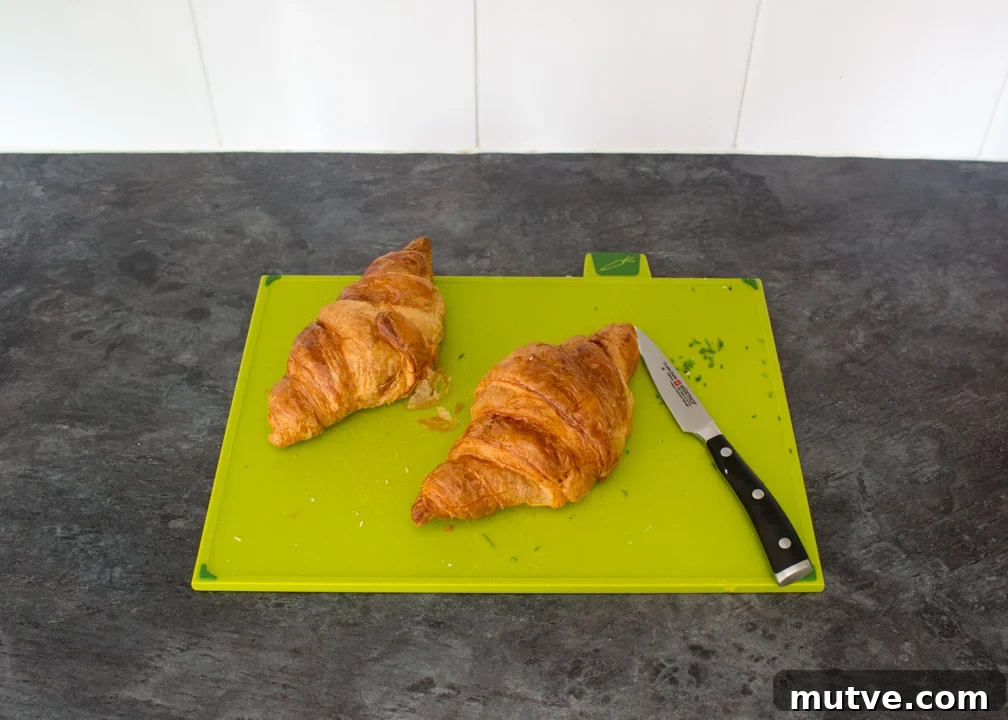 Cheese and Chive Scrambled Egg Croissant Recipe 7 Two croissants on a chopping board.