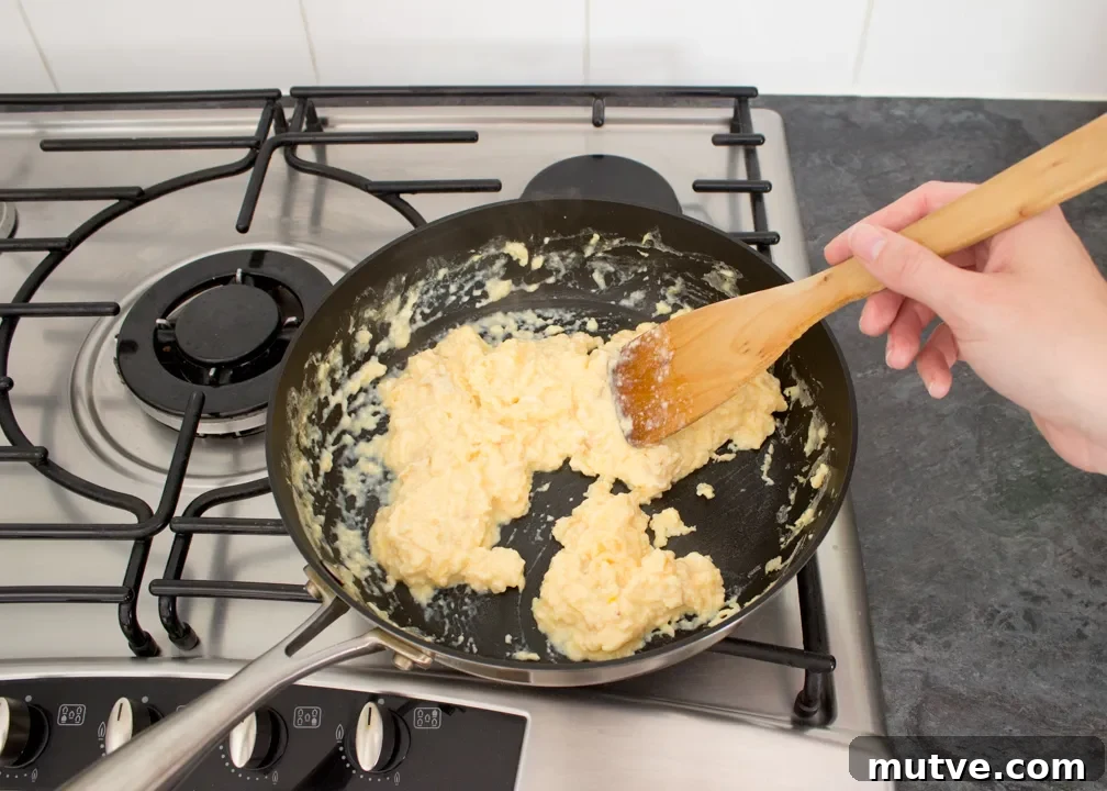 Cheese and Chive Scrambled Egg Croissant Recipe 13 Creamy scrambled eggs in a frying pan.