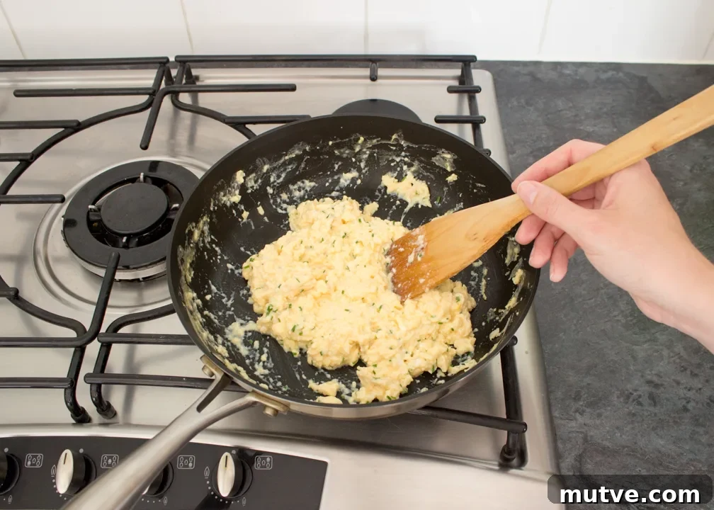 Cheese and Chive Scrambled Egg Croissant Recipe 14 Cheese and chive scrambled egg croissants in a frying pan.