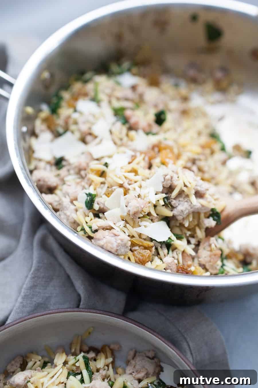 One-Pot Ground Turkey Pasta Recipe 6 A pan full of rice and meat with spinach and orzo.