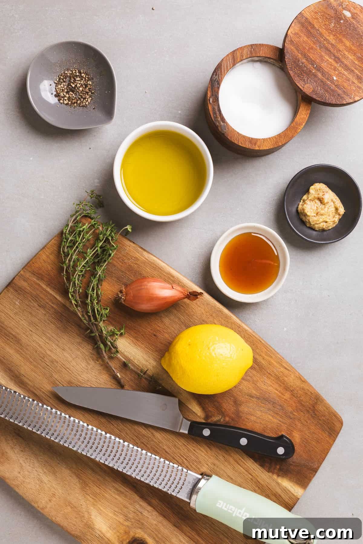 Ingredients for lemon thyme vinaigrette on a gray table.