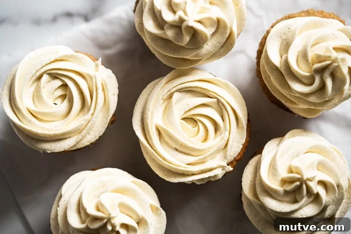 Fluffy Keto Vanilla Cupcakes: Gluten-Free and Paleo 3 Keto cream cheese buttercream frosting piped unto vanilla cupcakes
