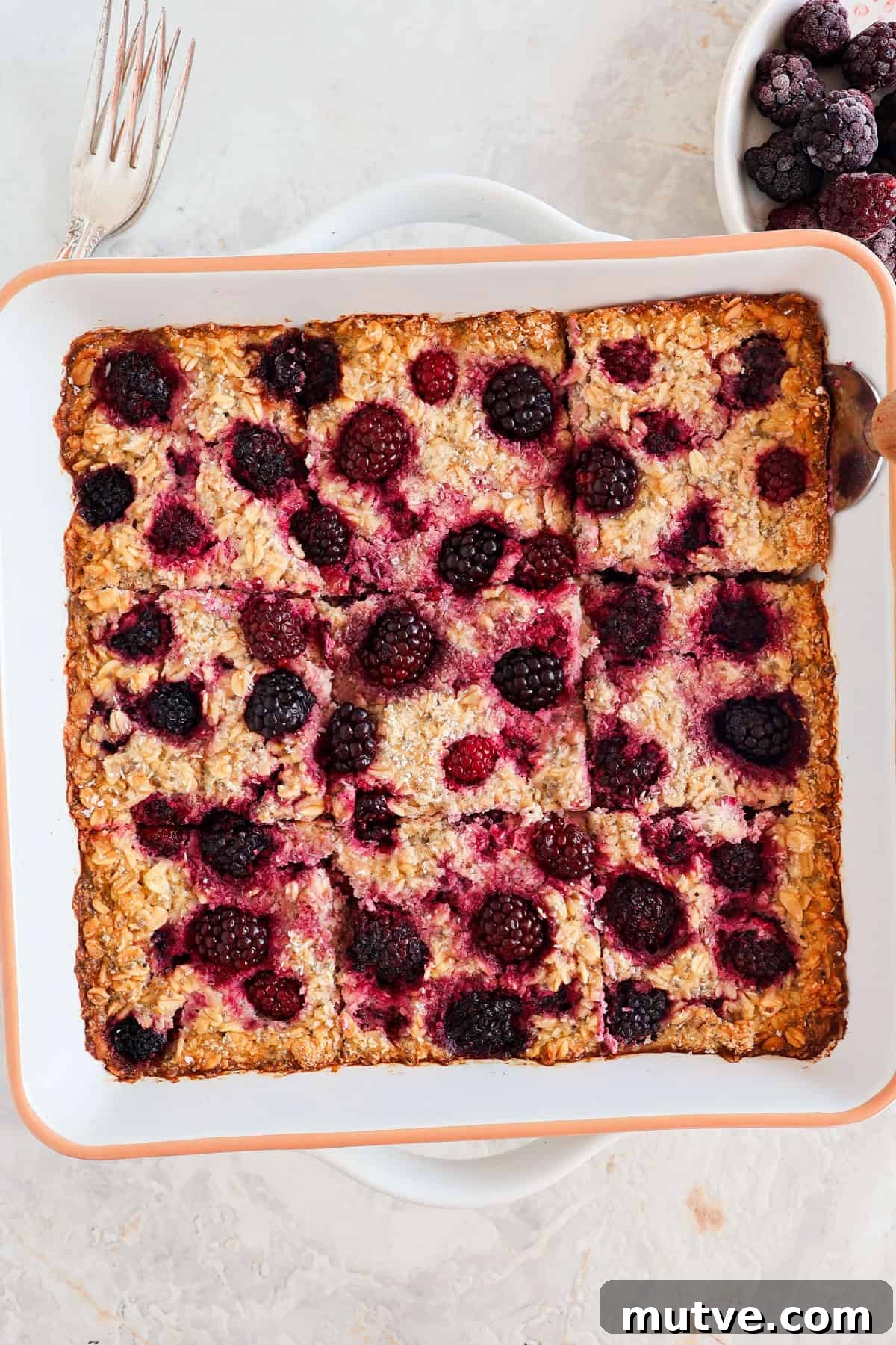 Blackberry Baked Oatmeal Recipe for Breakfast 3 Blackberry baked oatmeal sliced up in the baking dish.