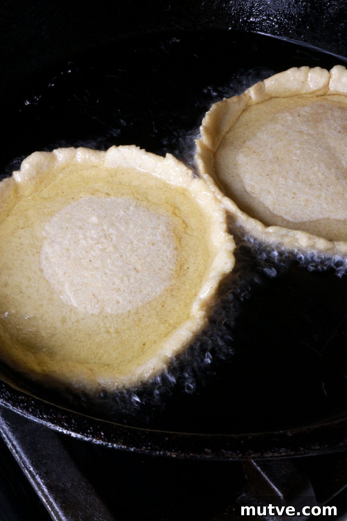 Traditional Mexican Refried Bean Sopes Recipe 8 Two sopes face up in frying pan with oil