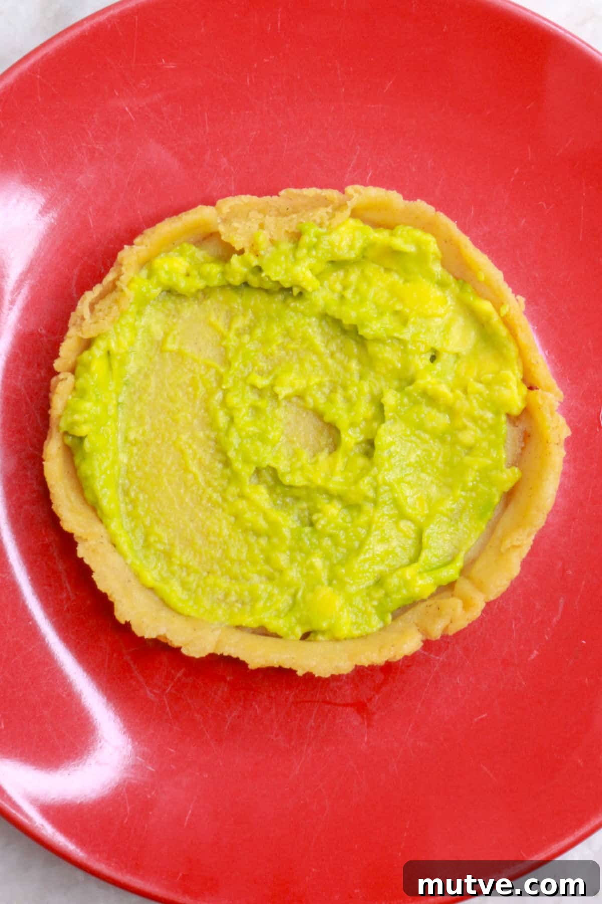 Traditional Mexican Refried Bean Sopes Recipe 9 A sope with a layer of mashed avocado