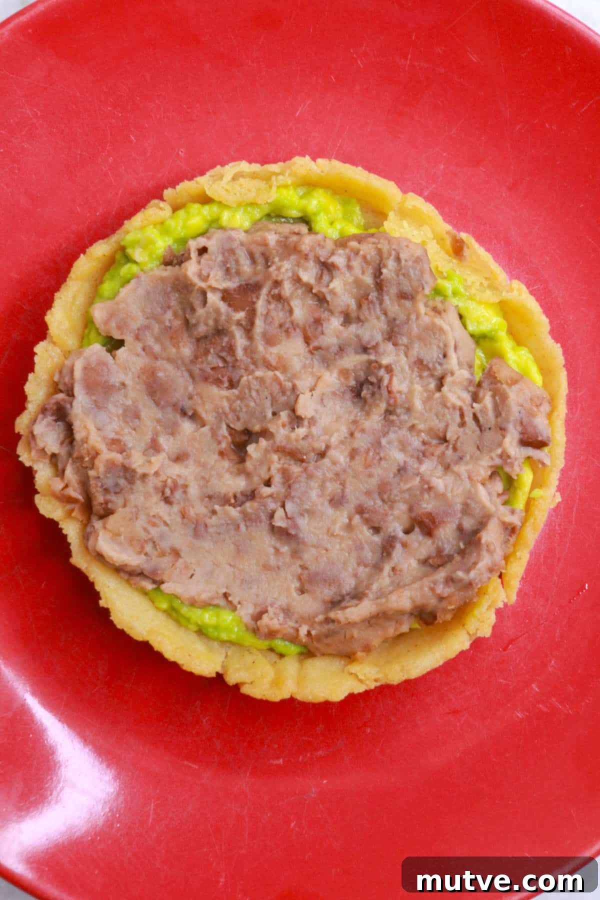 Traditional Mexican Refried Bean Sopes Recipe 10 A sope topped with mashed avocado and refried beans
