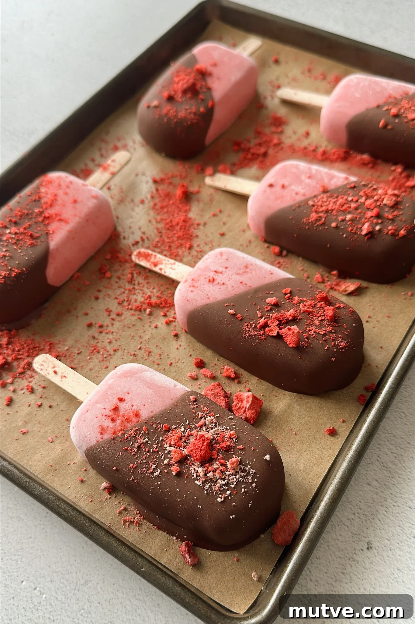 Homemade Frozen Strawberry Yogurt Bars Recipe 2 Frozen strawberry yogurt bars half dipped in chocolate.