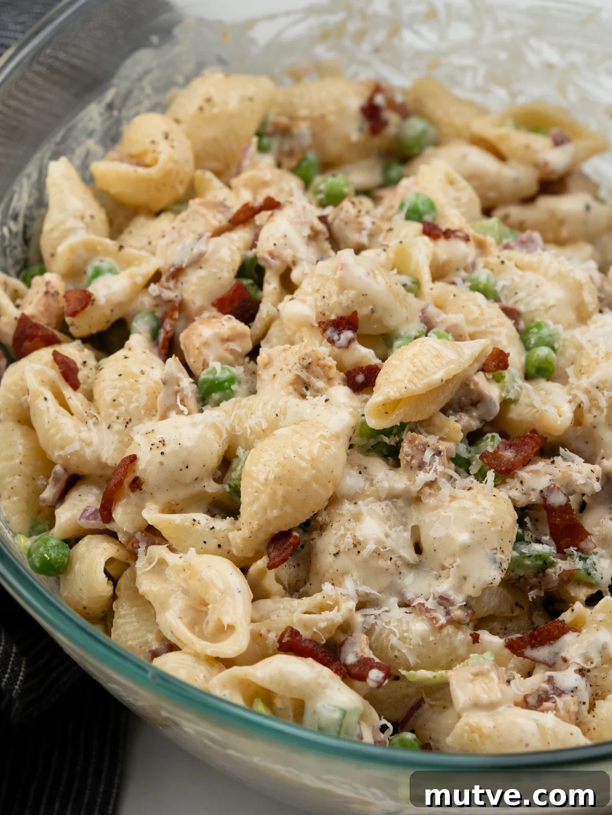 Creamy Chicken and Bacon Pasta Salad 10 Shell pasta with diced grilled chicken, crispy bacon, peas, bell peppers, onion tossed in a mayo dressing.