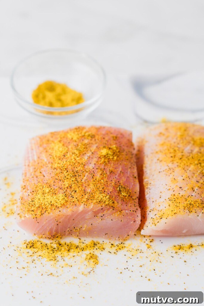 Crispy Air Fryer Mahi Mahi Recipe 6 seasoned mahi mahi fillets on a board.