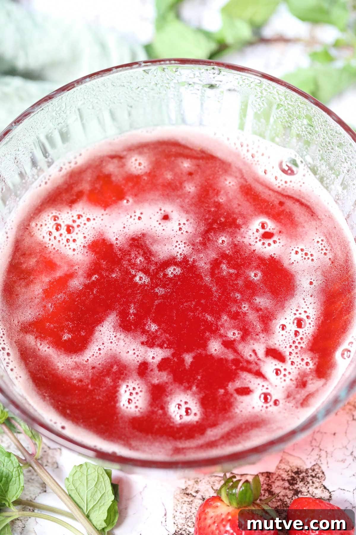 Strawberry simple syrup in a glass bowl.