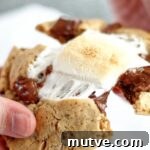 pulling apart smores cookie with melted marshmallow