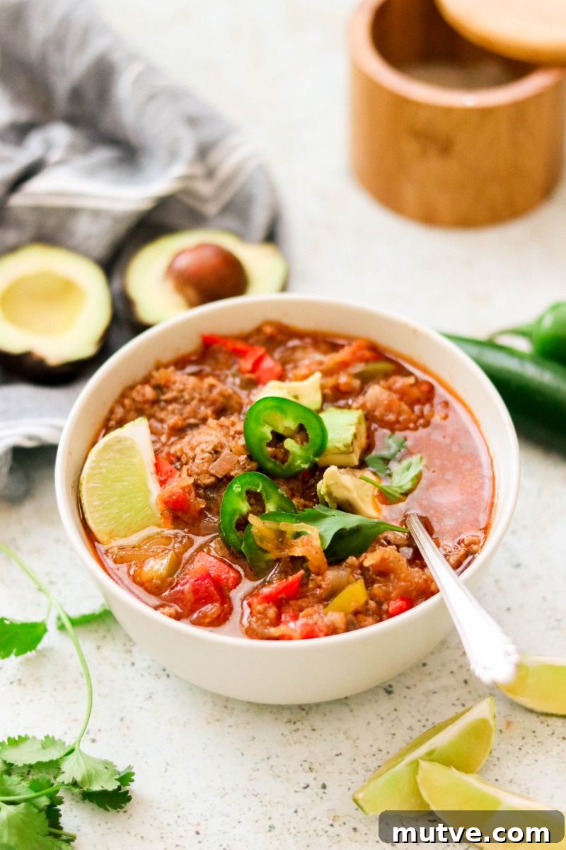 whole30 chili in a white bowl with a spoon.