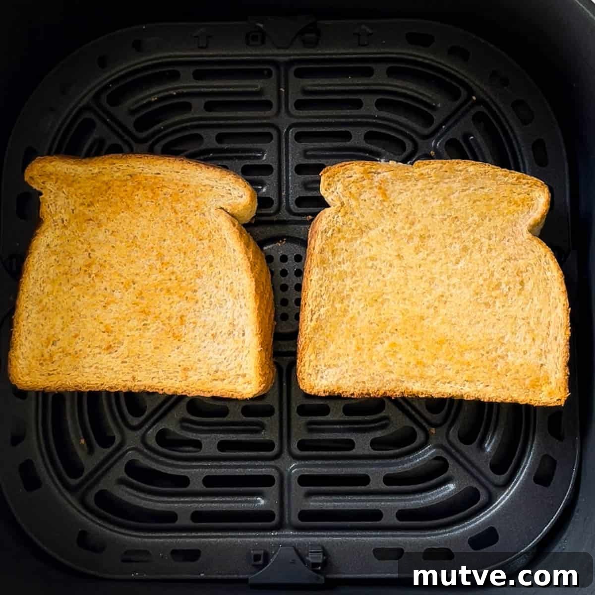 Cooked toast in the air fryer basket.