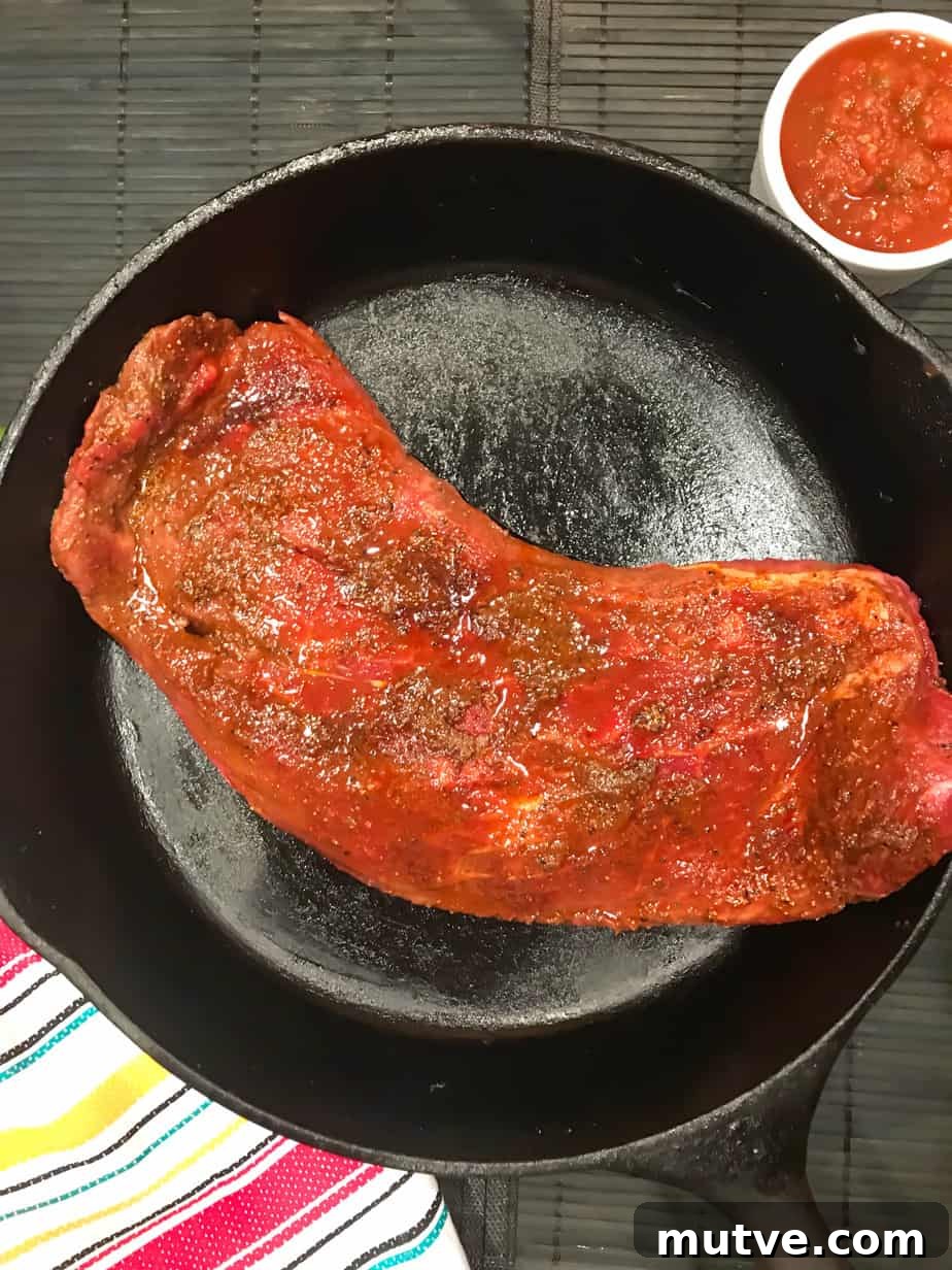 Sizzling Tex-Mex Fajitas Recipe with Peppers and Onions 6 Seasoned and marinated flank steak in cast iron skillet.