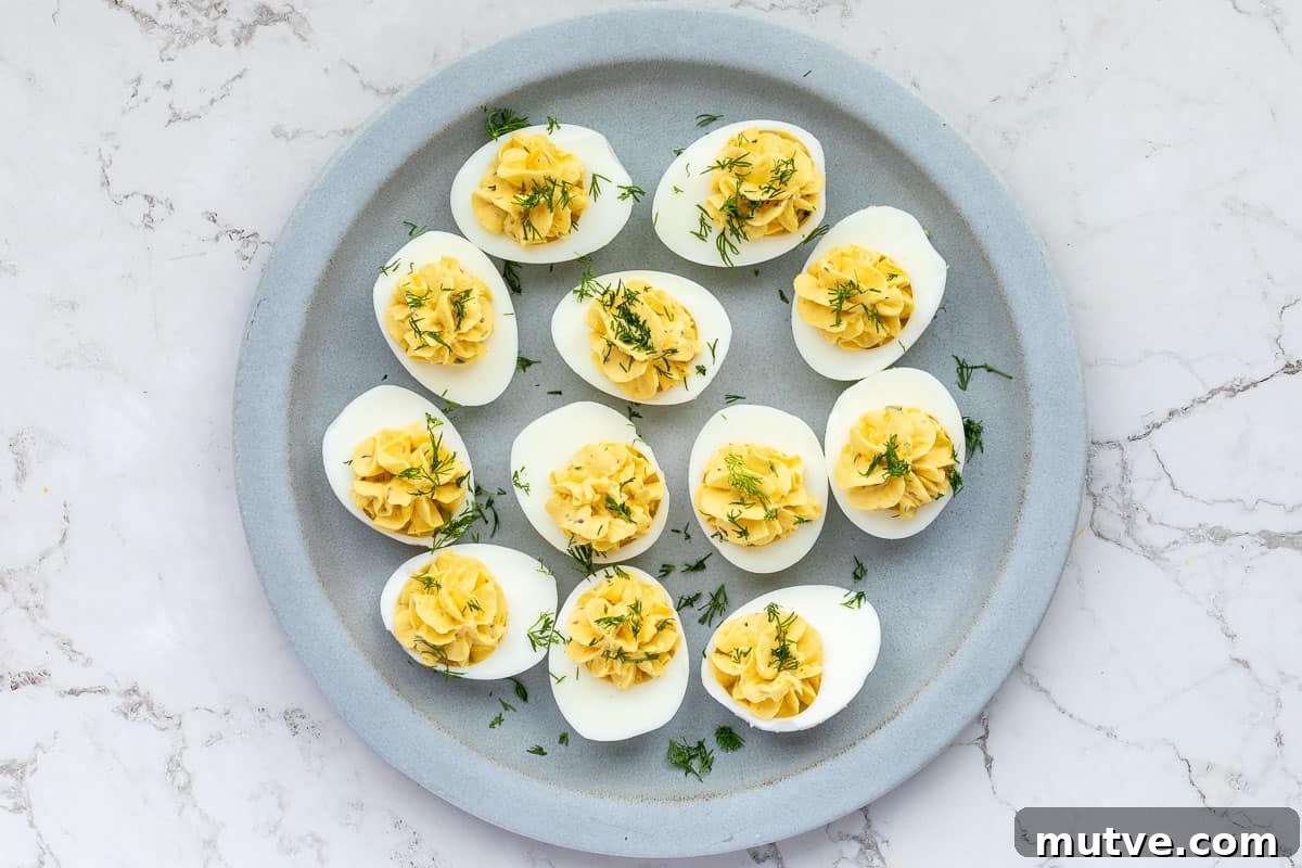 13 Vegetarian Thanksgiving Recipes Even Meat Eaters Will Love 2 deviled eggs on plate topped with fresh dill.