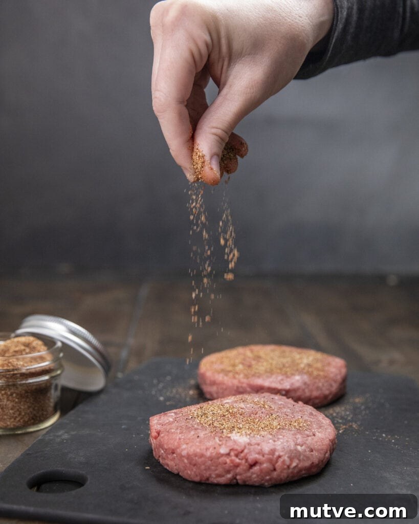 Jalapeño Popper Burgers Recipe: Stuffed and Cheesy 6 Seasoned burger patties on a grill