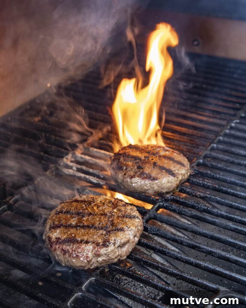 Jalapeño Popper Burgers Recipe: Stuffed and Cheesy 7 Toppings melting over burger patties