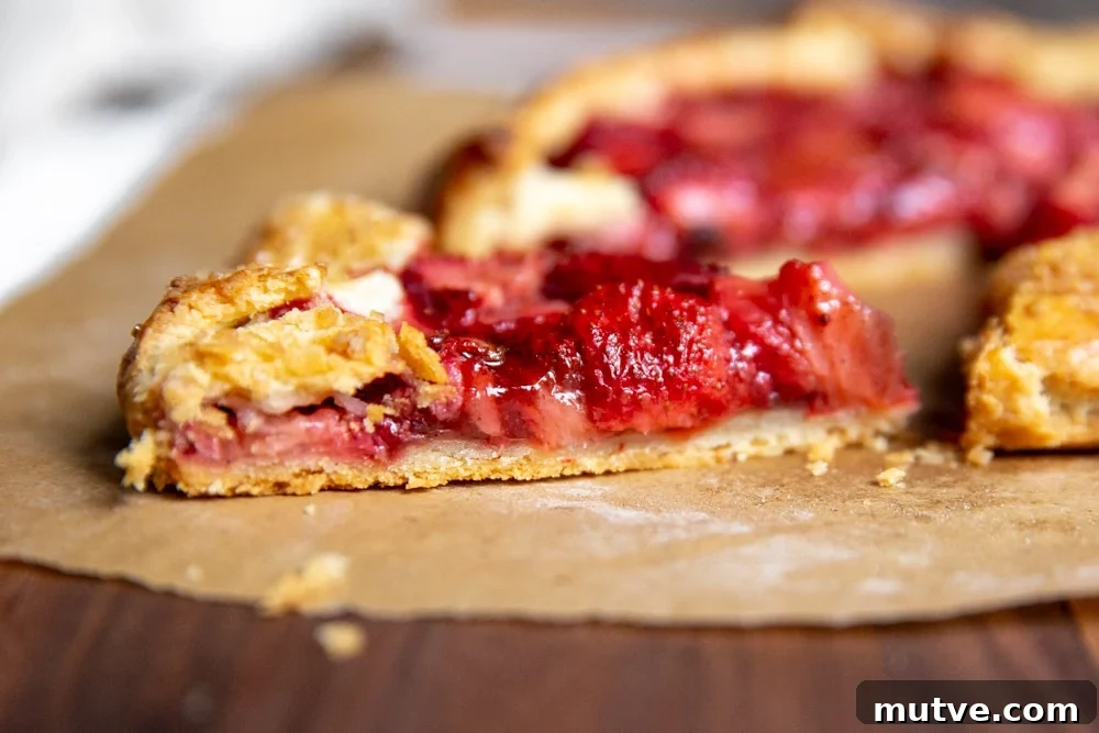 Side angle shot of a slice of strawberry galette.