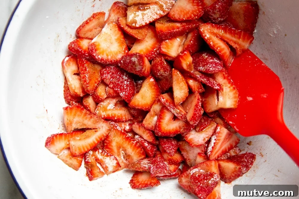 The strawberry galette filling in a bowl with a spatula.