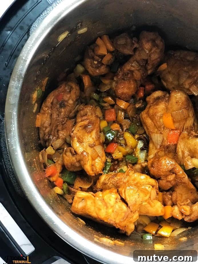 Boneless chicken thighs being sauteed with cajun spice in instant pot