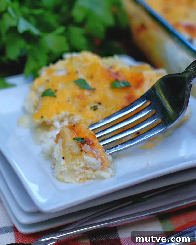 Cheesy Hashbrown Casserole on a plate with a fork