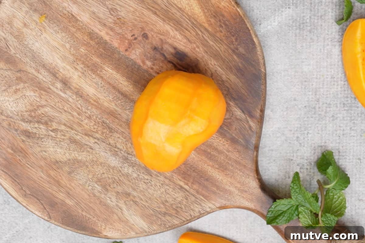 Peeled mango kept on a board.