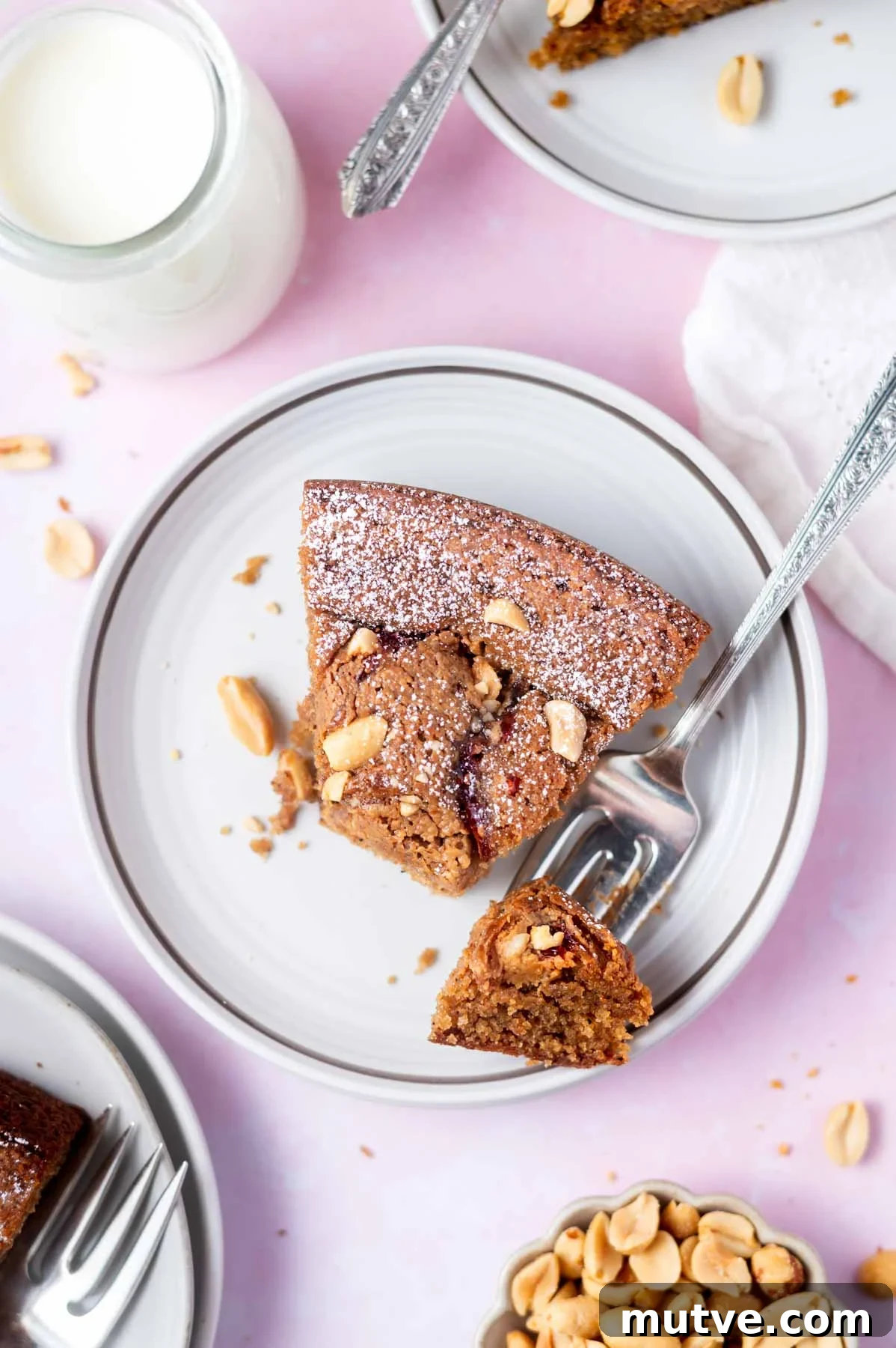 slice of cake on a plate with a bite on a fork