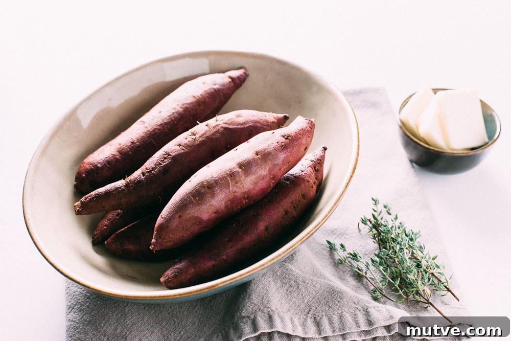 Hasselback Sweet Potatoes whole on cutting board