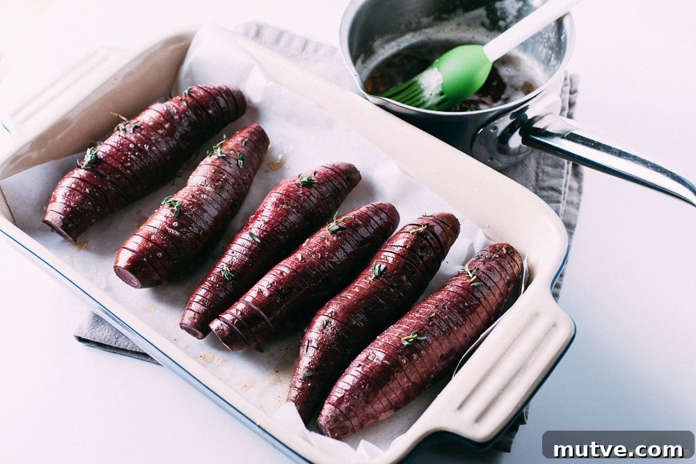 Hasselback sweet potatoes in baking dish ready to roast