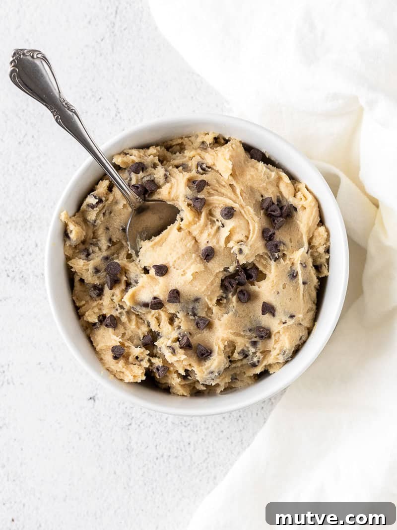 Edible Eggless Cookie Dough Recipe (Safe to Eat Raw) 6 edible cookie dough in a white bowl with a spoon
