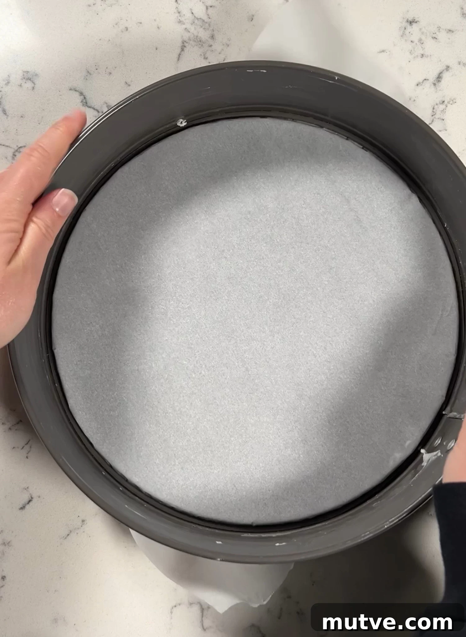 Lining a pan with parchment paper.