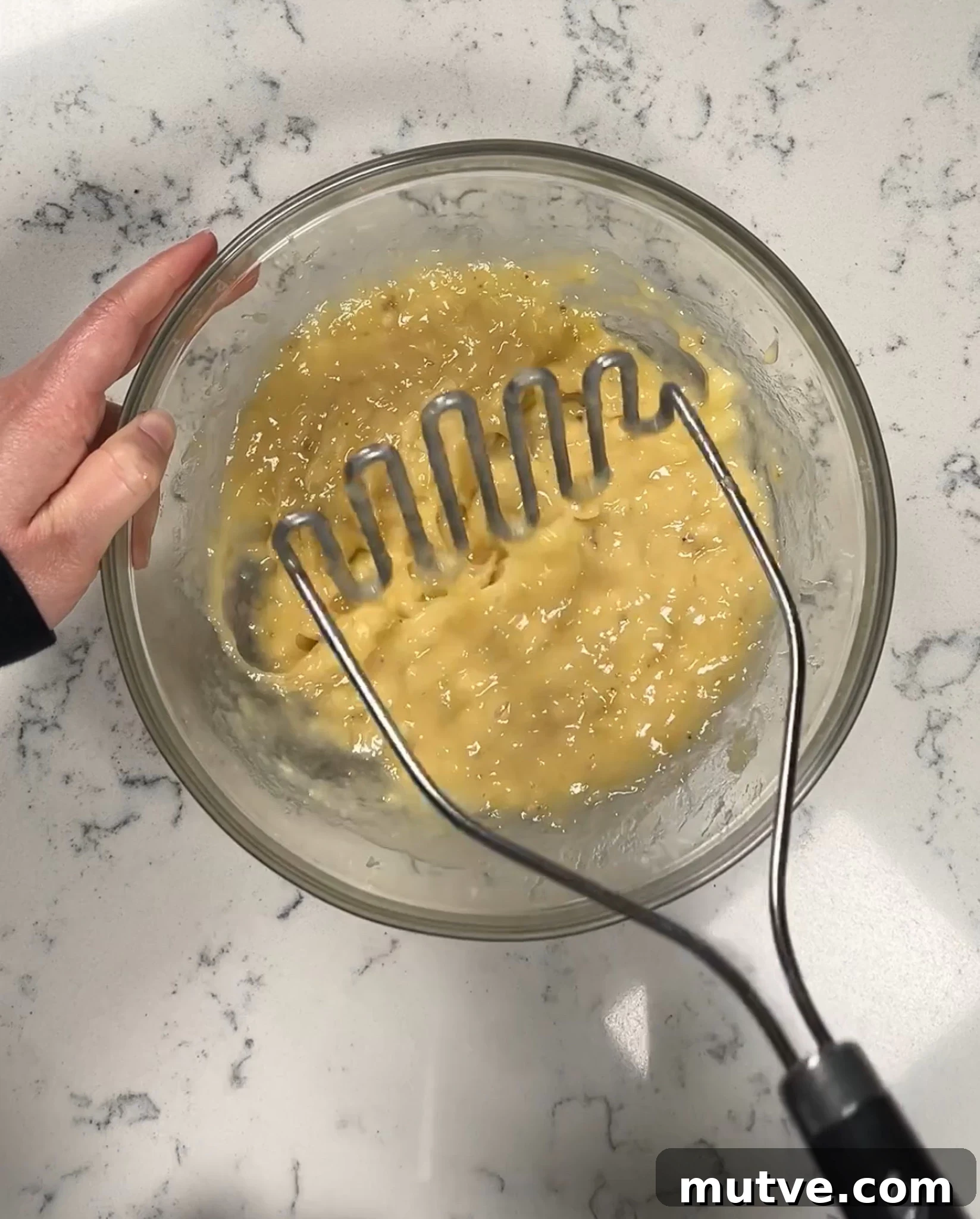 Mashing bananas in a bowl.