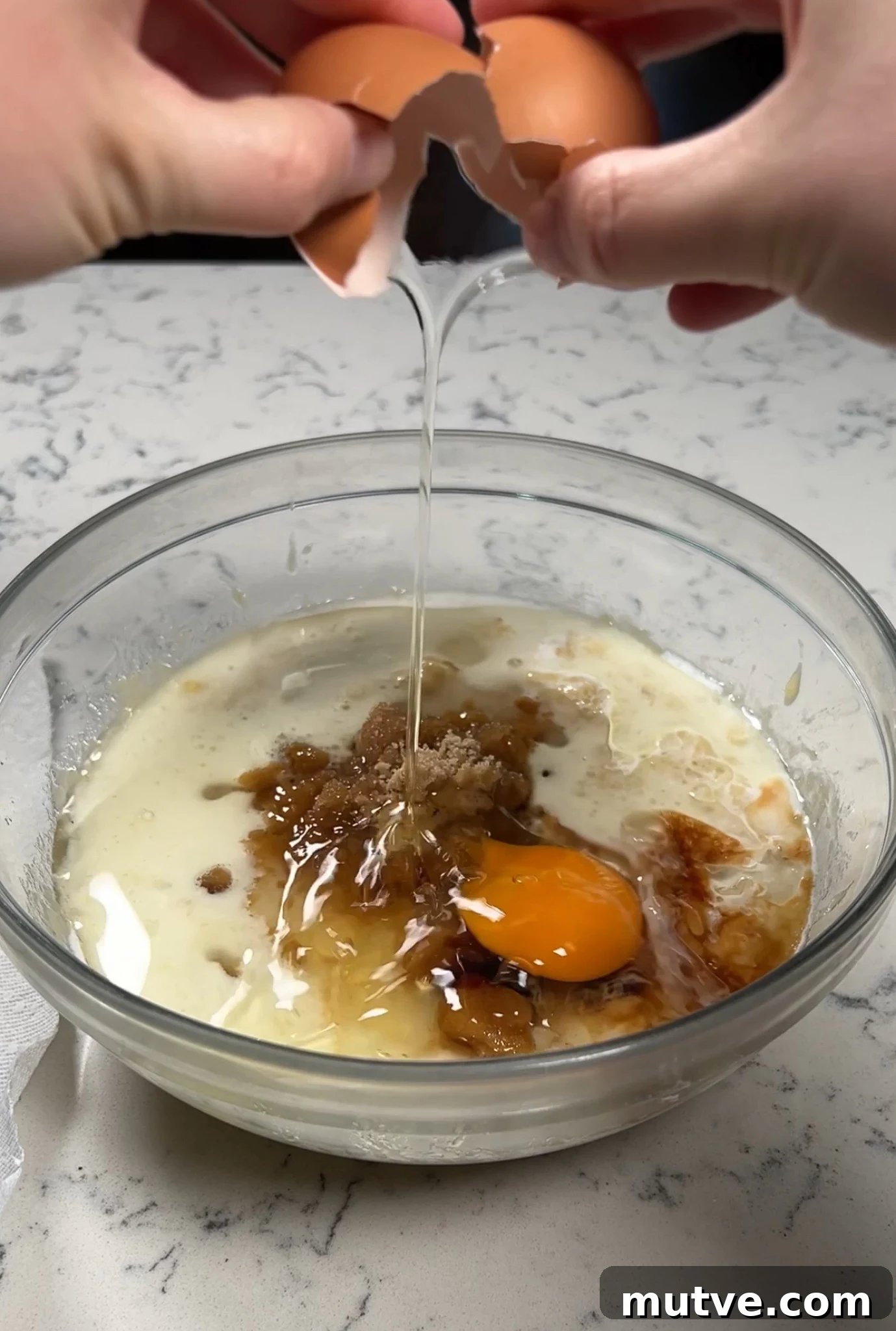 Adding wet ingredients to a bowl.