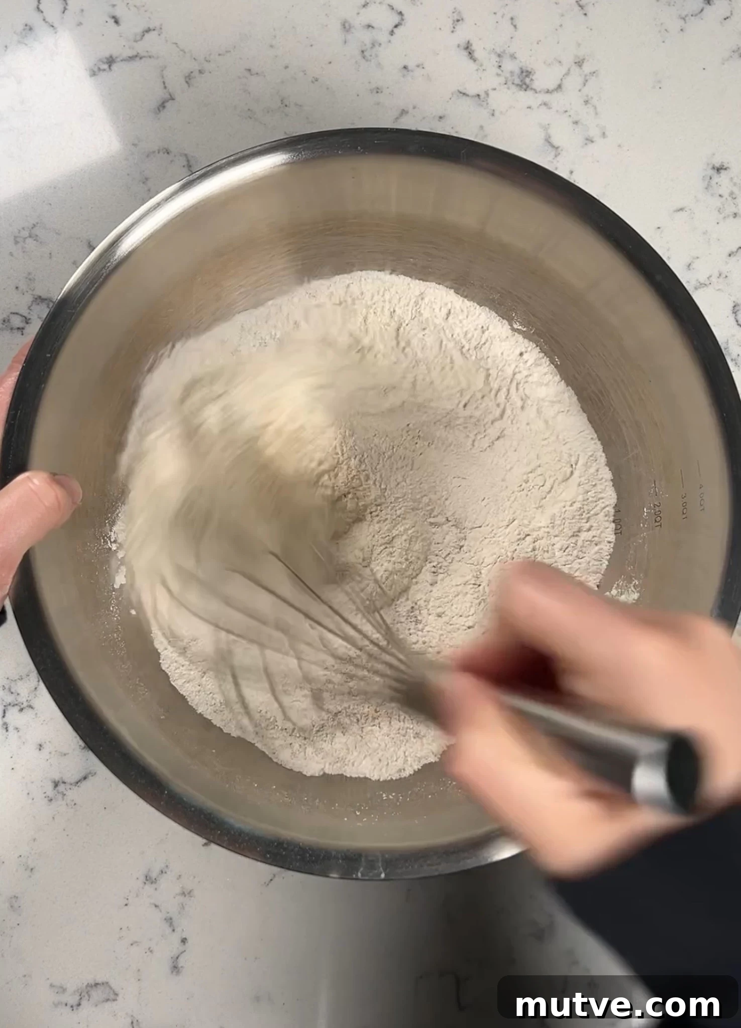 Whisking together dry ingredients.