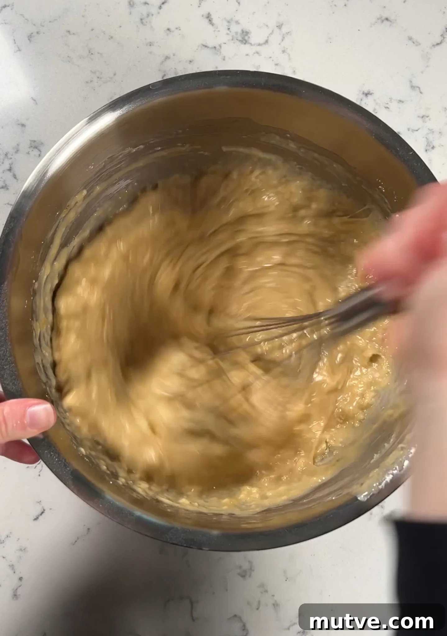 Whisking the batter together.