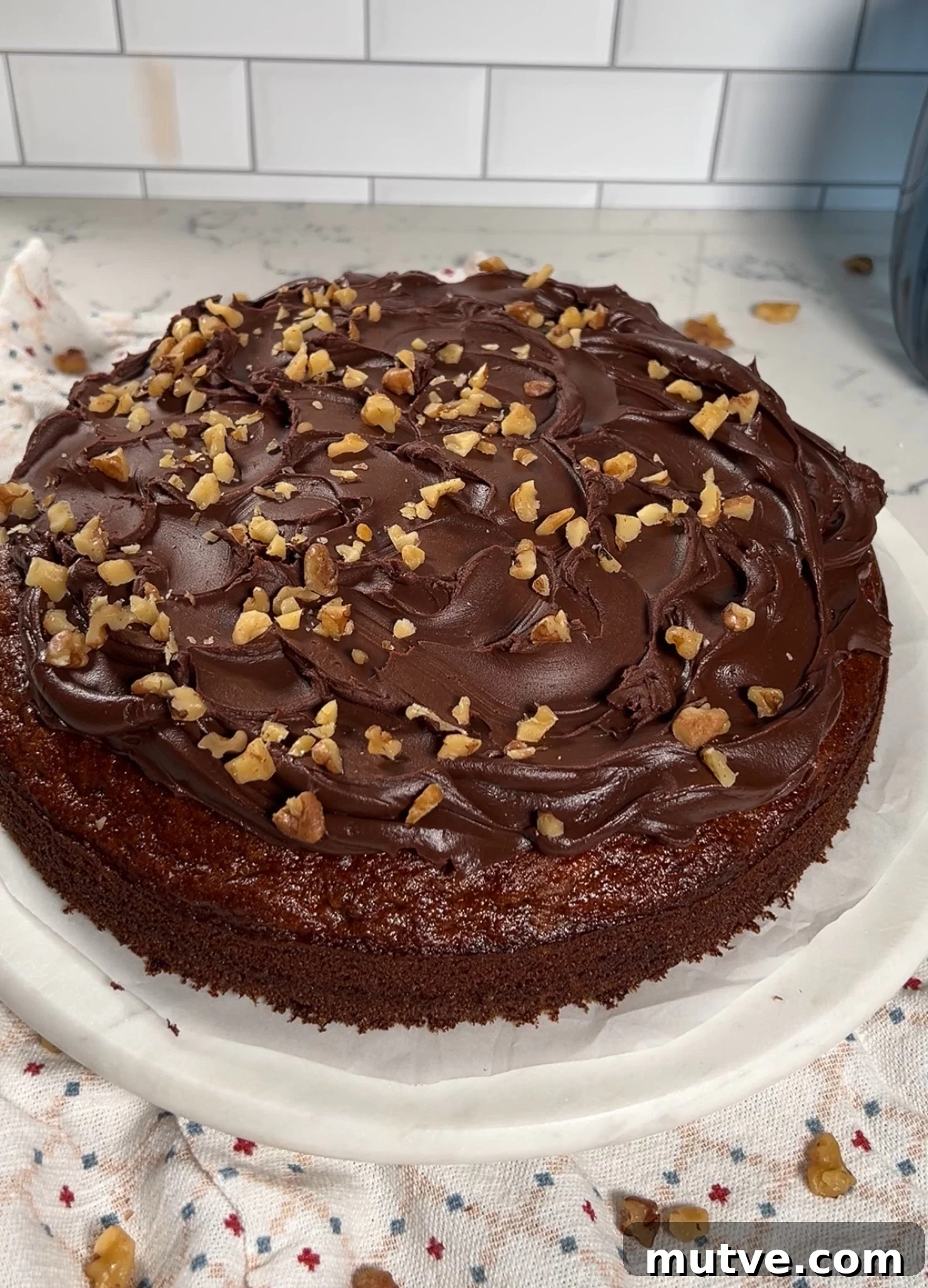 Decorating a cake with walnut pieces.