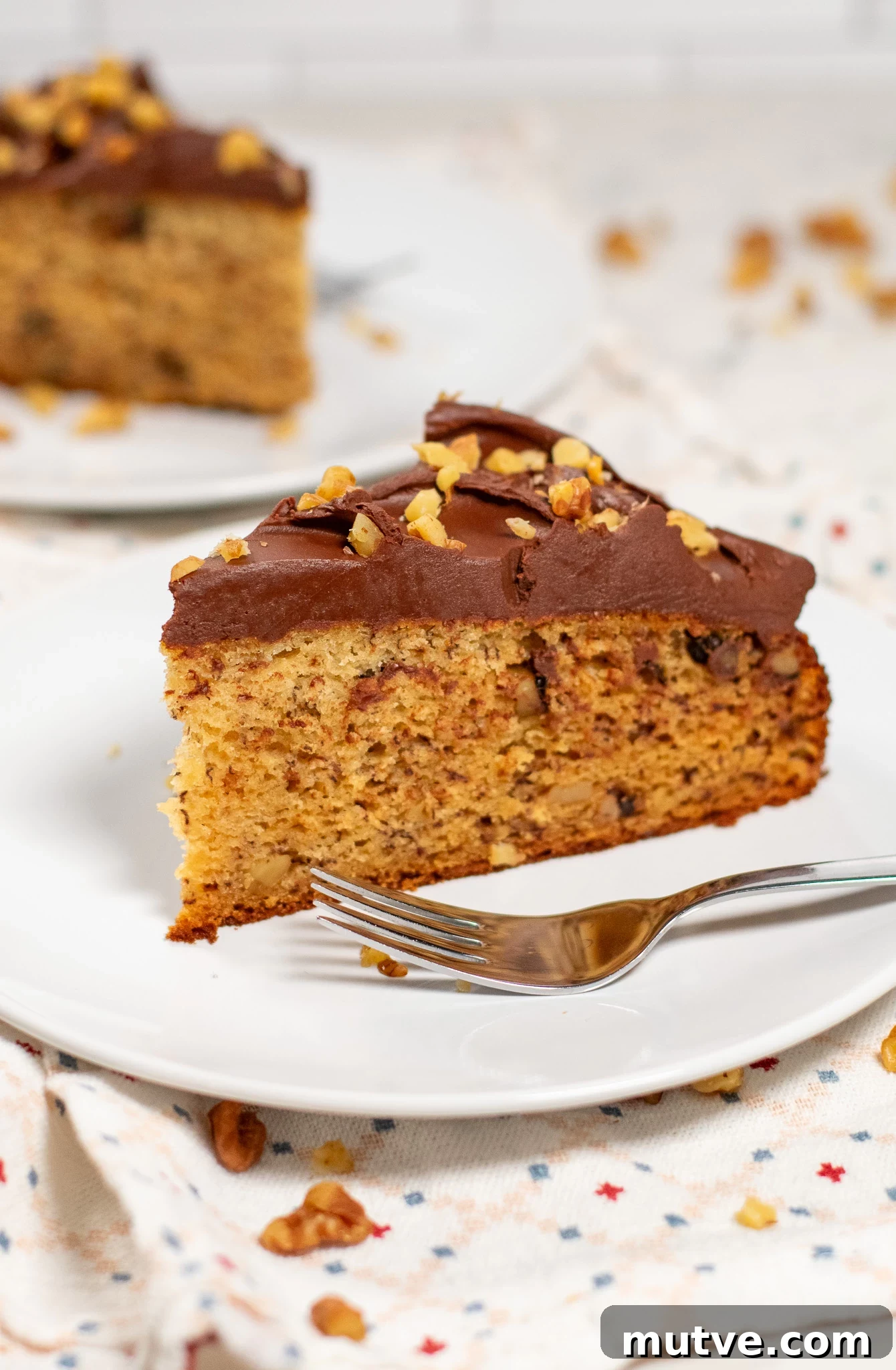 A slice of banana walnut cake on a plate.