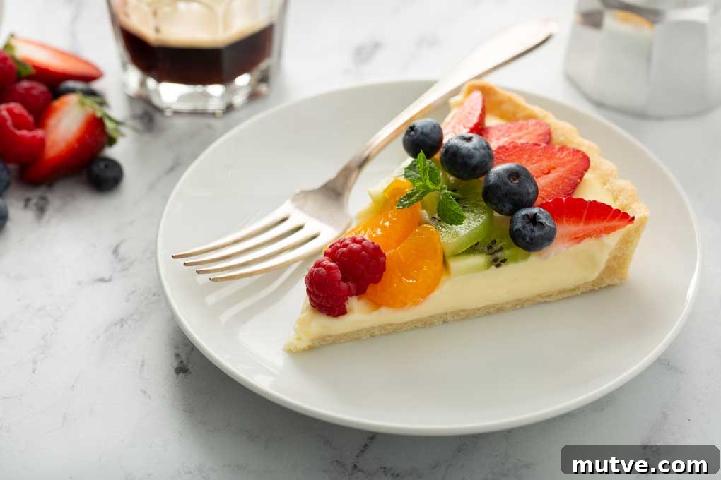 How to Make a Fresh Fruit Tart with Vanilla Custard 10 A slice of sweet tart on a white plate
