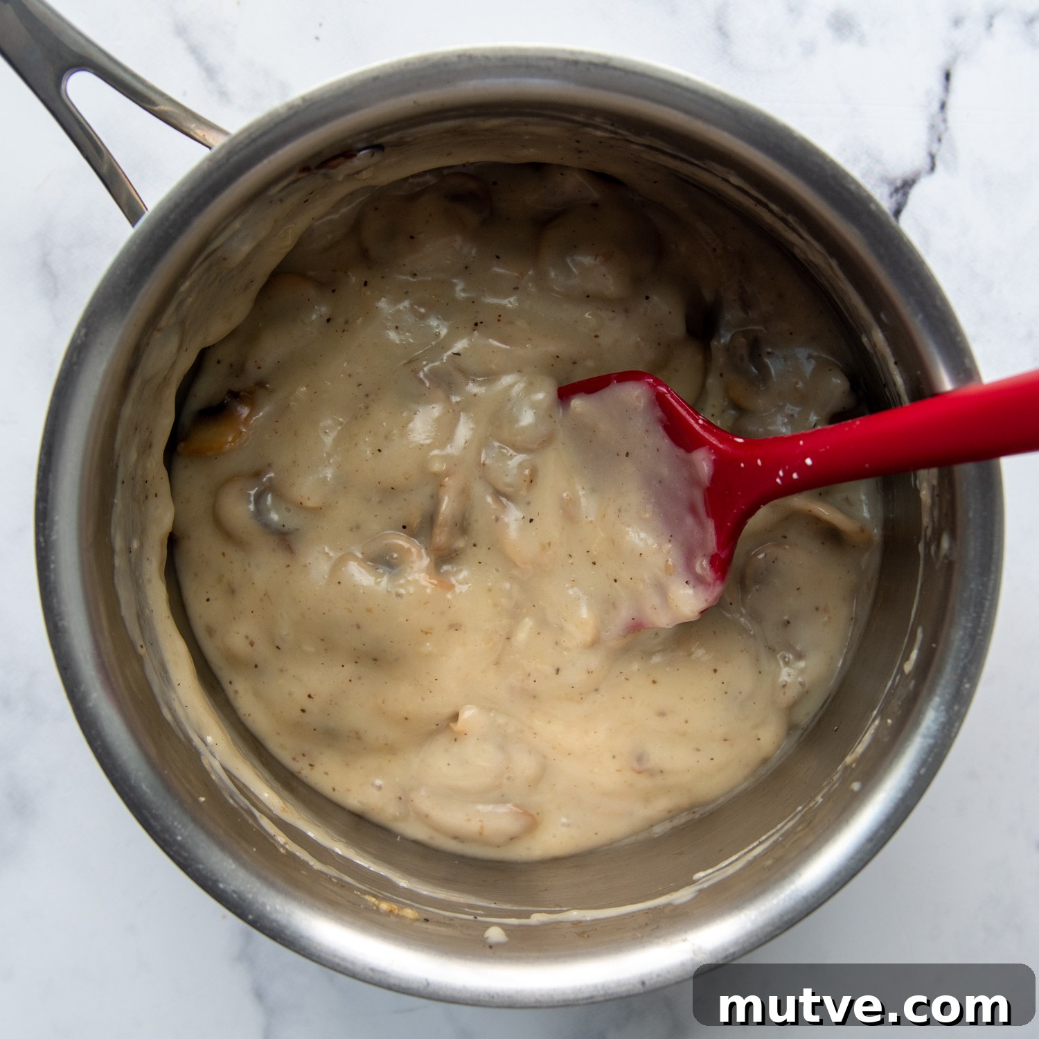 Gluten-Free Cream of Mushroom Soup Recipe 5 adding a little bit of milk to thin out the soup.