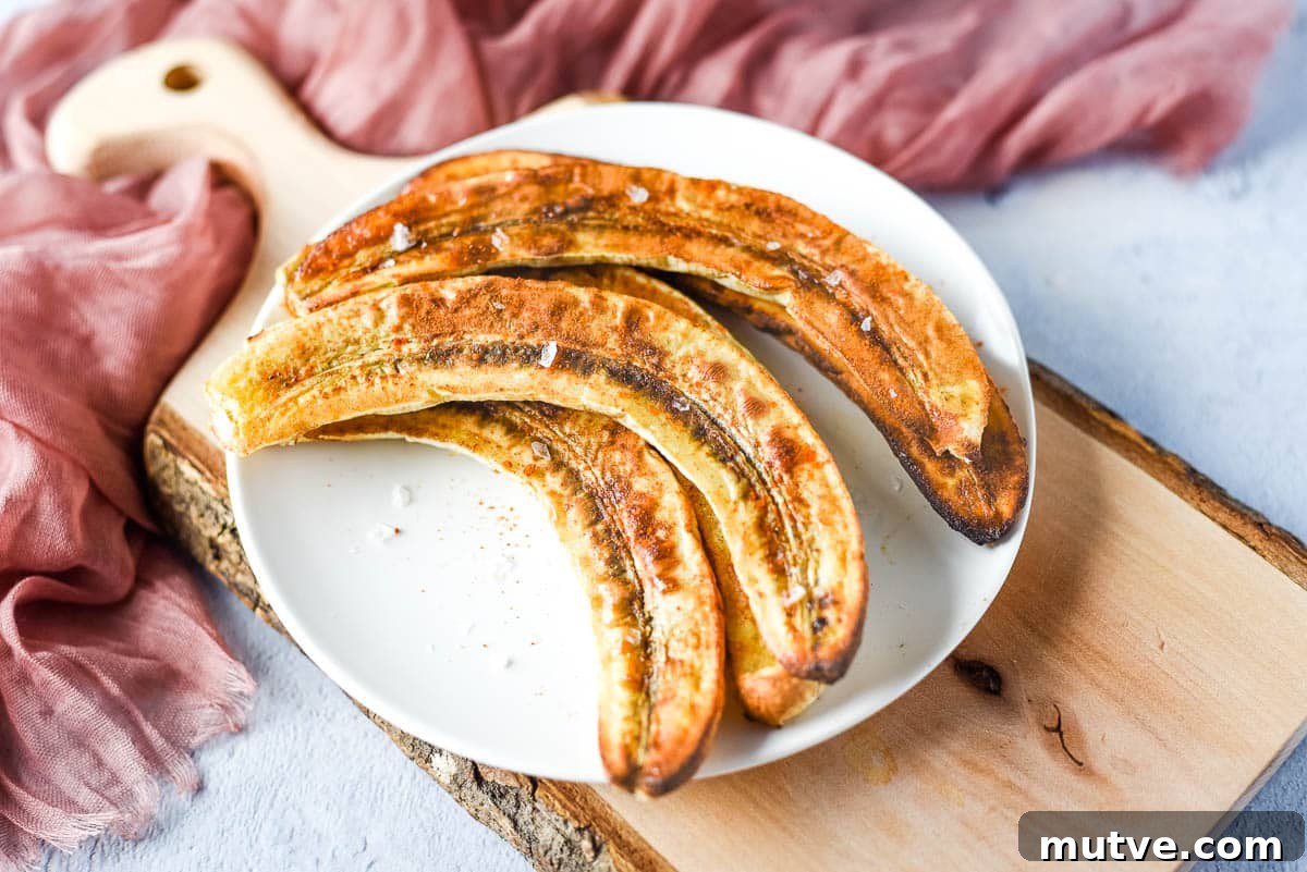 How to Cook With and Store Cinnamon 4 a pinch of flakey sea salt is added to the air fryer bananas sitting on a white plate.