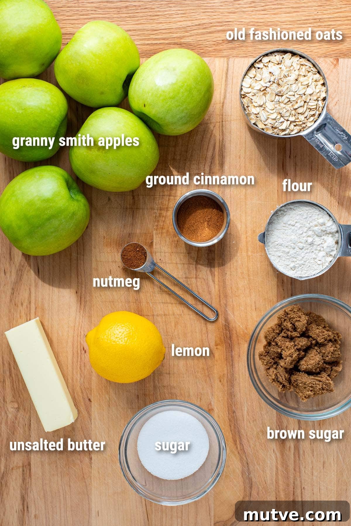 Skillet Apple Crisp Recipe with Cinnamon Oat Topping 3 Raw ingredients for apple crisp laid out on a wooden cutting board.